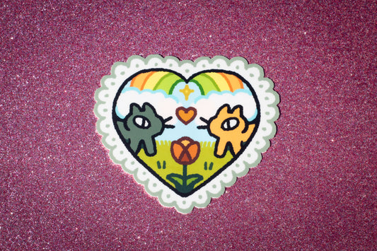 cats share a moment under a rainbow sticker - feb 2024